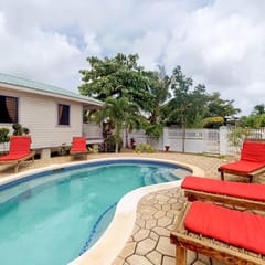 Cabana with a porch, hammock, & view of the pool & grilling area