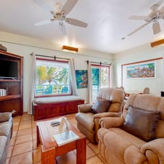 Colorful oceanfront condo with shared pool, WiFi, ocean view, and central AC