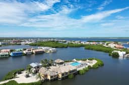Vibrant, colorful lagoon-front suite with pool access, scenic patio, & WD