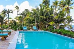 Serene oceanfront condo with shared pool, ocean view, WiFi, & partial AC