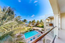 Serene oceanfront condo with shared pool, ocean view, WiFi, & partial AC