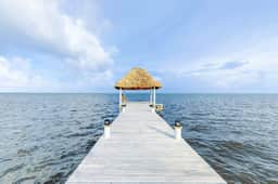 Beachfront condo with ocean views, WiFi, partial AC & shared pool, dock, kayaks