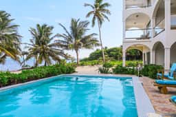 Beachfront condo with ocean views, WiFi, partial AC & shared pool, dock, kayaks