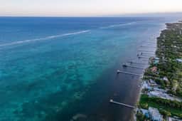Ground-floor ocean-view condo with dock, pool, full kitchen, & AC