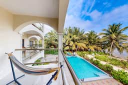 Beachfront condo with balcony, sea view, partial AC, pool, dock & kayaks