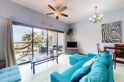 Beachfront condo with balcony, sea view, partial AC, pool, dock & kayaks