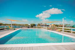 Beautiful lake-view villa with balcony, pool, & partial AC - near dining & shops