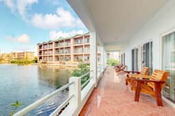 Beautiful lake-view villa with balcony, pool, & partial AC - near dining & shops