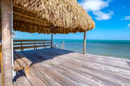 Tropical retreat villa with a pool, dock, bikes, canoes, balconies, and 360 views