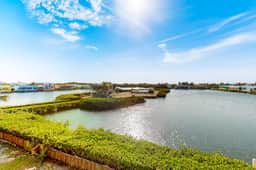 Comfortable condo with lagoon-view balcony, WiFi, AC & pool access