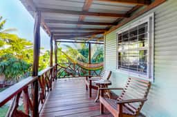 Charming guesthouse with balcony, hammock, WiFi & partial AC - walk to the beach