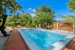 Dazzling beach stay with a balcony - pool, bikes, canoes, grill, & dock access