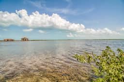 Waterfront resort villa with water views, balcony, full kitchen, & washer dryer