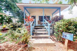 Cabana with a porch, hammock, & view of the pool & grilling area