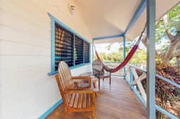 Cabana with a porch, hammock, & view of the pool & grilling area