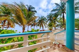 Colorful oceanfront condo with shared pool, WiFi, ocean view, and central AC