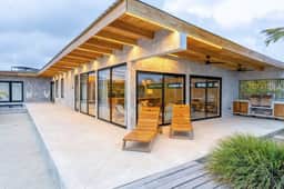 Stylish waterfront villa with pool, lush views & floor-to-ceiling windows