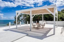 Luxurious beachfront home with private pool, rooftop grill, and sea views
