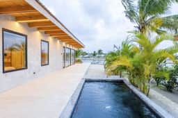 Stylish waterfront villa with pool, lush views & floor-to-ceiling windows