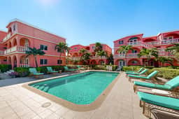 Breezy 2-story oceanfront condo with pool, sea views & partial AC