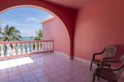 Breezy 2-story oceanfront condo with pool, sea views & partial AC