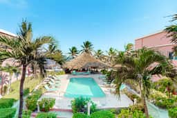 Ocean-view studio with pool, WiFi & partial AC - steps from the beach