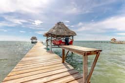 Beachfront condo with beach access, dock, pool, balcony, & ocean views