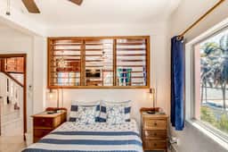 Beachfront condo with beach access, dock, pool, balcony, & ocean views