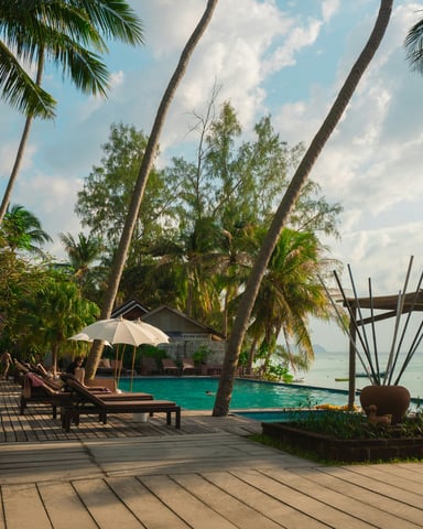Tropical resort pool deck with lounge chairs and ocean view