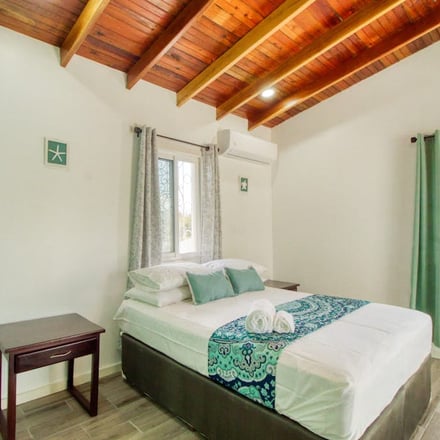 Bedroom with wood-beam ceiling, Caye Caulker