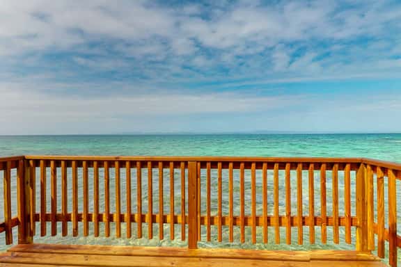 Overwater cabin with oceanfront deck, island kitchen & sea breeze views - Image 1