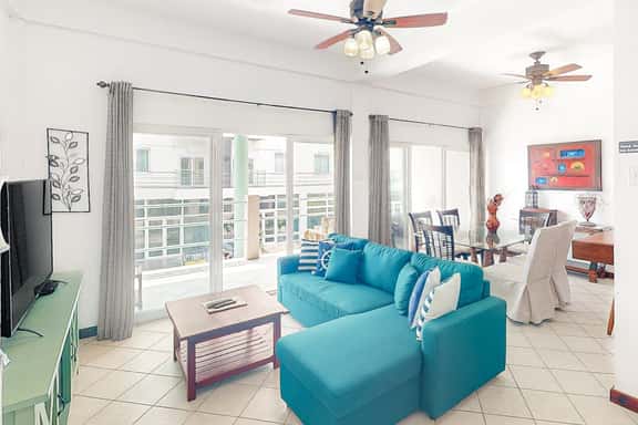 Stylish condo near the beach with pool, fast WiFi, partial ocean views & AC - Image 1