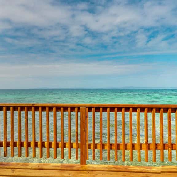 Overwater cabin with oceanfront deck, island kitchen & sea breeze views - Image 1
