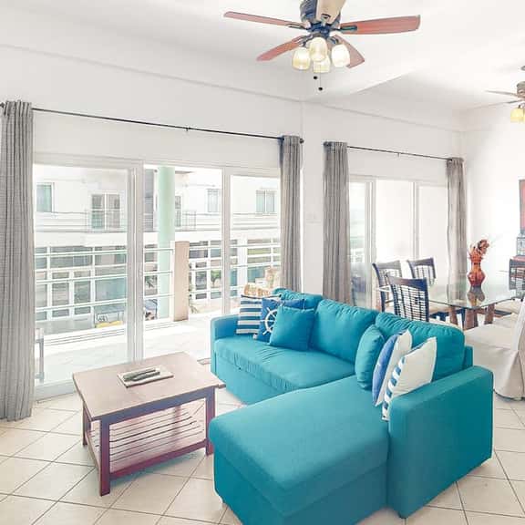 Stylish condo near the beach with pool, fast WiFi, partial ocean views & AC - Image 1