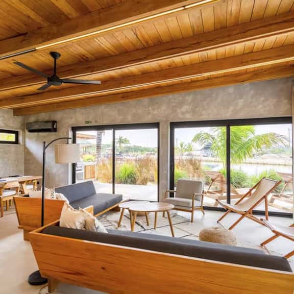 Stylish waterfront villa with pool, lush views & floor-to-ceiling windows - Image 1