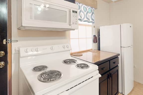 Homey suite in town w WiFi, partial AC, shared pool & veranda - walk to beach