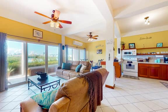 Vibrant, colorful lagoon-front suite with pool access, scenic patio, & WD