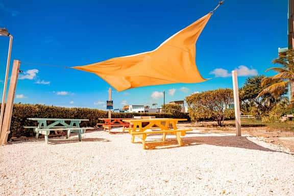 Vibrant, colorful lagoon-front suite with pool access, scenic patio, & WD