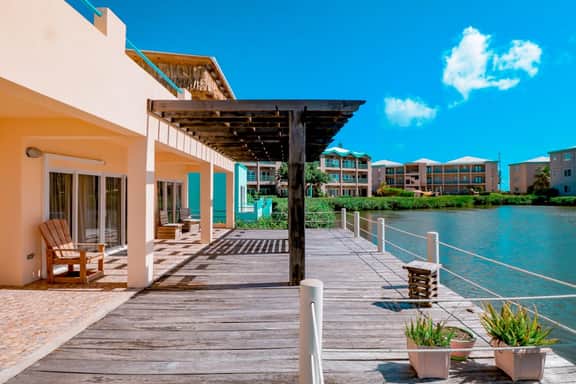Cozy Waterfront Villa Home w Shared Pool, Water Views, WiFi, & AC - Walk to the Beach