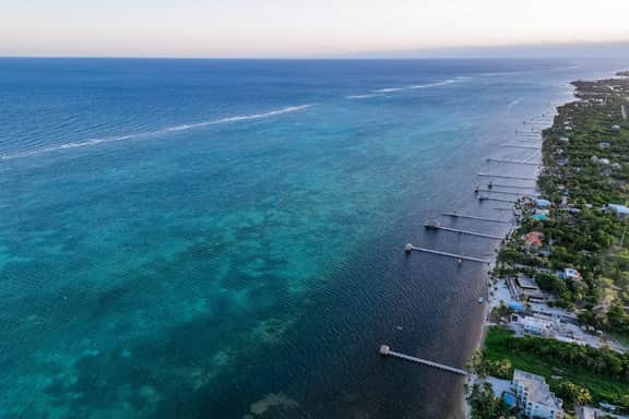 Ground-floor ocean-view condo with dock, pool, full kitchen, & AC
