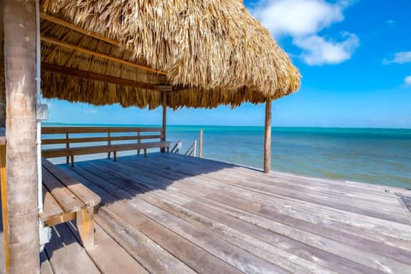 Tropical retreat villa with a pool, dock, bikes, canoes, balconies, and 360 views