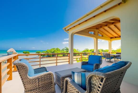Tropical retreat villa with a pool, dock, bikes, canoes, balconies, and 360 views