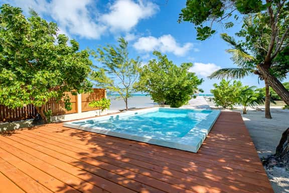 Tropical retreat villa with a pool, dock, bikes, canoes, balconies, and 360 views