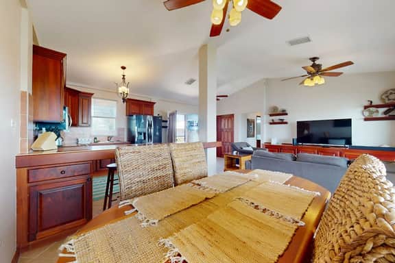 Sunny waterfront villa with outdoor pool, balcony, & AC