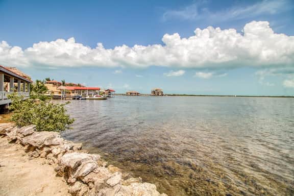 Waterfront resort villa with water views, balcony, full kitchen, & washer dryer