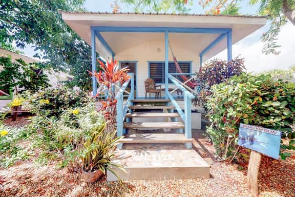 Cabana with a porch, hammock, & view of the pool & grilling area