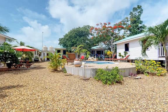 Cabana with a porch, hammock, & view of the pool & grilling area