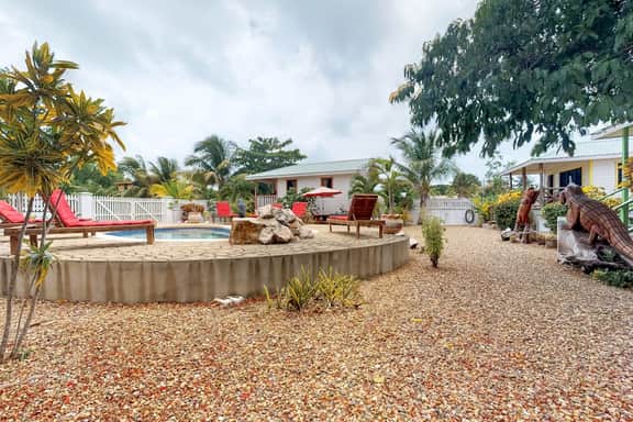 Wood cabana with a porch, pool view, WiFi, and a shared common area with grills