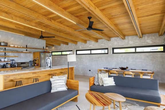 Stylish waterfront villa with pool, lush views & floor-to-ceiling windows