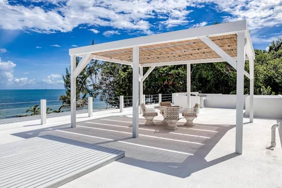 Luxurious beachfront home with private pool, rooftop grill, and sea views